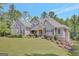 Charming two-story home with stone accents, beautiful landscaping, and a lush green lawn at 265 Beverly Farms Dr, Sharpsburg, GA 30277