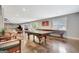 Open game room with table tennis, lounge seating, home theater, and abundant light from doors leading outside at 265 Beverly Farms Dr, Sharpsburg, GA 30277