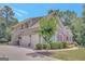 Two-story home featuring an attached three-car garage and manicured landscaping at 265 Beverly Farms Dr, Sharpsburg, GA 30277