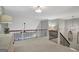 Second-floor hallway with a view of lower level. Includes carpeted floors and decorative light fixtures at 265 Beverly Farms Dr, Sharpsburg, GA 30277