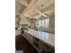 Open kitchen with a center island, modern appliances, and farmhouse sink with natural light at 265 Beverly Farms Dr, Sharpsburg, GA 30277