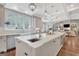 Spacious kitchen boasts a large island, farmhouse sink, pendant lighting, and an open layout to the living area at 265 Beverly Farms Dr, Sharpsburg, GA 30277