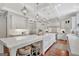 Gourmet kitchen with oversized island, custom range hood, seating, and plenty of counter space for preparing meals at 265 Beverly Farms Dr, Sharpsburg, GA 30277