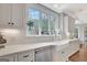 Bright kitchen features white cabinets, subway tile backsplash, marble countertops, and stainless steel appliances at 265 Beverly Farms Dr, Sharpsburg, GA 30277