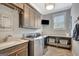 Well-organized laundry room featuring modern appliances, counter space, and ample storage cabinets at 265 Beverly Farms Dr, Sharpsburg, GA 30277