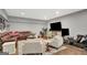Finished basement living room featuring a leather couch, chairs, and television at 265 Beverly Farms Dr, Sharpsburg, GA 30277