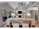 Bright living room with fireplace, built-in shelving, high ceilings, and hardwood floors for a cozy atmosphere at 265 Beverly Farms Dr, Sharpsburg, GA 30277