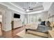 Elegant main bedroom featuring a trey ceiling, ceiling fan and large windows allowing ample natural light at 265 Beverly Farms Dr, Sharpsburg, GA 30277