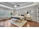 Serene main bedroom with tray ceiling, plantation shutters, and a comfortable seating area at 265 Beverly Farms Dr, Sharpsburg, GA 30277