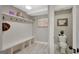Well lit mudroom that leads into a half-bath with white tiling and decorative elements at 265 Beverly Farms Dr, Sharpsburg, GA 30277
