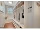 Mudroom featuring custom shelving, ample storage and natural light from a window at 265 Beverly Farms Dr, Sharpsburg, GA 30277