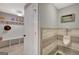 A well lit mudroom with white shelving, hooks, and a small men's room with urinal at 265 Beverly Farms Dr, Sharpsburg, GA 30277