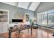 Bright office features custom built-ins, hardwood floors, and a comfortable sitting area at 265 Beverly Farms Dr, Sharpsburg, GA 30277