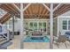 Covered outdoor patio with a dining area, grill, and access to the backyard at 265 Beverly Farms Dr, Sharpsburg, GA 30277