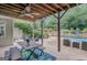 Covered patio featuring an outdoor dining area with views of the pool and backyard at 265 Beverly Farms Dr, Sharpsburg, GA 30277