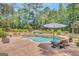 Relaxing pool area with a stone waterfall, spa, and lush greenery, perfect for outdoor entertaining at 265 Beverly Farms Dr, Sharpsburg, GA 30277