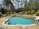 This swimming pool features a stone retaining wall, mature trees, and a basketball hoop at 265 Beverly Farms Dr, Sharpsburg, GA 30277
