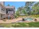 Inviting backyard pool with umbrella and stone accents provides a relaxing outdoor retreat at 265 Beverly Farms Dr, Sharpsburg, GA 30277