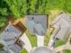 Aerial view of home with gray shingle roof and professionally landscaped yard surrounded by mature trees at 931 Hidden Falls Se Ln, Smyrna, GA 30082