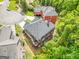 Aerial view of multi-story home featuring attached garage, large lot and mature trees at 931 Hidden Falls Se Ln, Smyrna, GA 30082