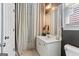 Well-lit bathroom featuring a white vanity, decorative mirror, and elegant fixtures at 931 Hidden Falls Se Ln, Smyrna, GA 30082