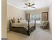 Comfortable bedroom featuring a large window, a ceiling fan, and a plush bed for a restful retreat at 931 Hidden Falls Se Ln, Smyrna, GA 30082