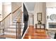 Elegant foyer showcasing hardwood floors, a staircase, and a fireplace with stone accents at 931 Hidden Falls Se Ln, Smyrna, GA 30082