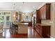 Spacious kitchen boasting hardwood floors, dark wood cabinets, an island with barstool seating, and natural light at 931 Hidden Falls Se Ln, Smyrna, GA 30082