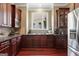 Gourmet kitchen featuring dark wood cabinets, granite countertops, a window above the sink, and stainless steel appliances at 931 Hidden Falls Se Ln, Smyrna, GA 30082
