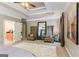 Bright and airy main bedroom featuring a seating area, elegant décor, and a view to the ensuite bathroom at 931 Hidden Falls Se Ln, Smyrna, GA 30082