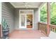 Outdoor patio with ceiling fan looks out on manicured backyard and an open living space at 931 Hidden Falls Se Ln, Smyrna, GA 30082