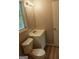 This well-lit bathroom features a toilet, vanity, and a window for natural light at 3858 Trenton Dr, Snellville, GA 30039