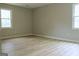 A new bedroom boasts ample natural light through two windows, complemented by vinyl floors at 3858 Trenton Dr, Snellville, GA 30039