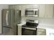 Kitchen with stainless steel refrigerator, oven and microwave at 3858 Trenton Dr, Snellville, GA 30039
