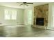 Living room featuring a stone fireplace and updated flooring at 3858 Trenton Dr, Snellville, GA 30039