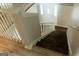 Classic staircase with a wooden railing, wooden stairs, and new flooring leading to the front door at 3858 Trenton Dr, Snellville, GA 30039