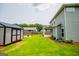 Grassy backyard with shed, flower bed, and home with covered porch at 309 Dean Ct, Temple, GA 30179