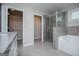 Modern bathroom featuring shower, soaking tub, and access to walk-in closet at 309 Dean Ct, Temple, GA 30179