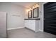 Bathroom featuring double vanity with sleek countertop and black door at 309 Dean Ct, Temple, GA 30179