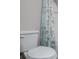 Toilet in bathroom next to shower with light blue floral shower curtain at 309 Dean Ct, Temple, GA 30179