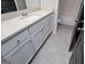 Bathroom vanity with white cabinets, quartz countertop and tile flooring at 309 Dean Ct, Temple, GA 30179