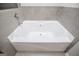 Clean white bathtub with tile surround, perfect for relaxing at 309 Dean Ct, Temple, GA 30179