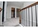 An upstairs hallway with carpeted floors, wood and iron railings, and views to rooms at 309 Dean Ct, Temple, GA 30179