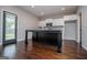 Bright kitchen features a black island and white cabinets at 309 Dean Ct, Temple, GA 30179