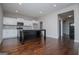 Kitchen featuring white cabinets, stainless steel appliances, black island, and hardwood flooring at 309 Dean Ct, Temple, GA 30179