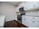 Modern kitchen with stainless steel appliances and white cabinets at 309 Dean Ct, Temple, GA 30179