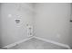 Empty laundry room with gray tile flooring and utility hookups at 309 Dean Ct, Temple, GA 30179