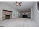 The open-concept living room and kitchen boast carpeted floors, a fireplace, and natural light at 309 Dean Ct, Temple, GA 30179