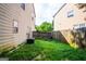 Backyard featuring green grass, a wooden fence, and an AC unit in the yard at 2938 Cottesford Se Way, Smyrna, GA 30080