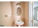 Stylish powder room featuring a pedestal sink, oval mirror, and modern lighting for a touch of elegance at 2938 Cottesford Se Way, Smyrna, GA 30080
